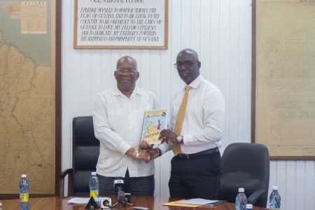 Minister of Finance, Winston Jordan (left) receiving the Financial Intelligence Unit’s (FUI) 2018 report from FIU’s Director, Matthew Langevine. (DPI photo)