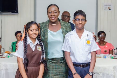 Education Minister Nicolette Henry with the two top performers Dave Chowtie of Graham’s Hall Primary and Venisha Lall of CV Nunes Primary (DPI photo)
