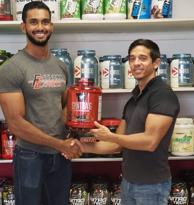 Dillon Mahadeo and  receiving supplements from CEO of Fitness Express Jamie McDonald.