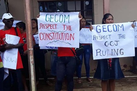 PPP Protestors in Martakai, Region One, with placards calling on GECOM to respect the Constitution.
