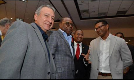 Tourism Minister Edmund Bartlett (second left) shares a moment with Floyd Green (second right), minister of state in the Ministry of Industry, Commerce and Agriculture; Richard Pandohie (right), newly elected president of the JMEA; and Metry Seaga, immediate past JMEA president and chairman of the Manufacturing Technical Working Group, at the launch of the fifth staging of the Christmas in July at The Jamaica Pegasus hotel yesterday.