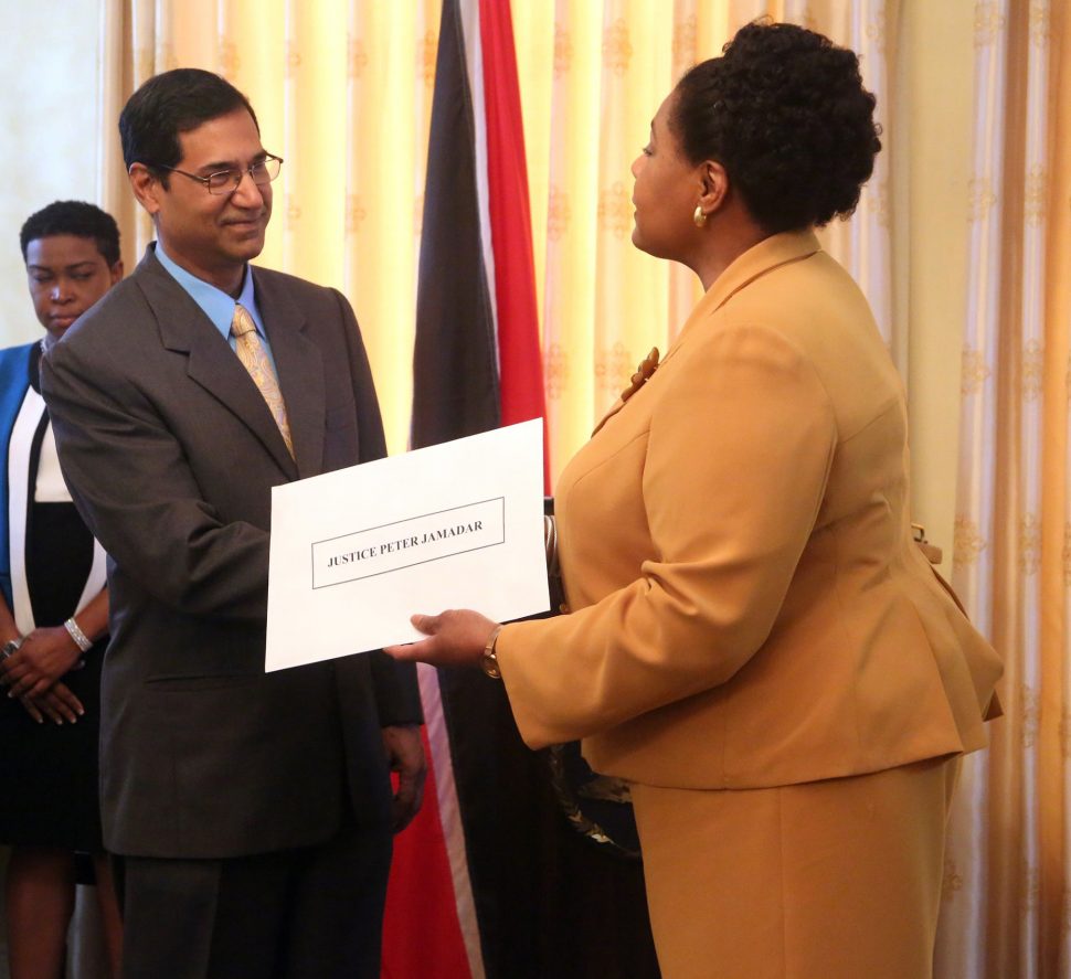 Justice Peter Jamadar receives his letter of appointment from President Paula-Mae Weekes as a Judge of the Caribbean Court of Justice at the Office of the President, in Port-of-Spain, on Thursday.