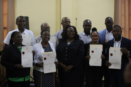 Chief Magistrate Ann McLennan (centre in front row) on Friday flanked by nine of the 18 Mayors and Deputy Mayors sworn in as Ex-officio Justices of the Peace. Those sworn in were Mayors: Winifred Rebecca Heywood, Gifford Eldon Marshall, David Samuel Adams, Waneka Odetta Arrindell; Deputy Mayors: Alfred Anthony Mentore, Wainwright Wilton Gordon McIntosh, Arita Peggy Embleton, Juewayne Mendonca-Burrows, and Wainewright Odida Bethune.
