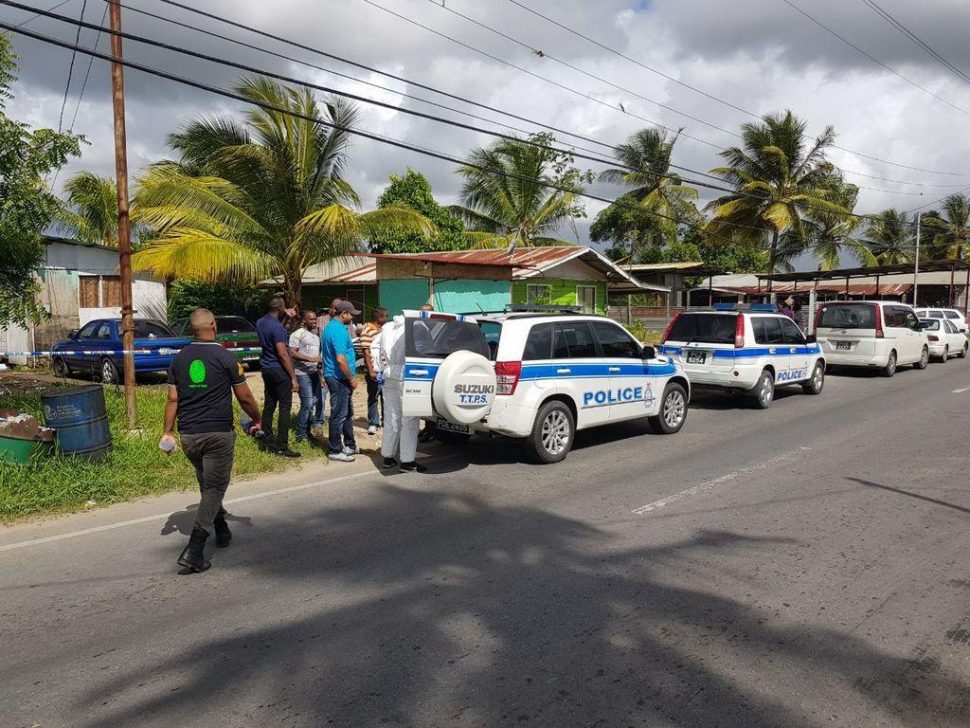 Police at the scene of a triple murder in Cunupia. Photo: TREVOR WATSON