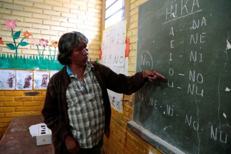 Teacher Blas Duarte shows letters in the Maka language at a school used by children of the Paraguayan ethnic group Maka, in Mariano Roque Alonso, Paraguay July 18, 2019. REUTERS/Jorge Adorno