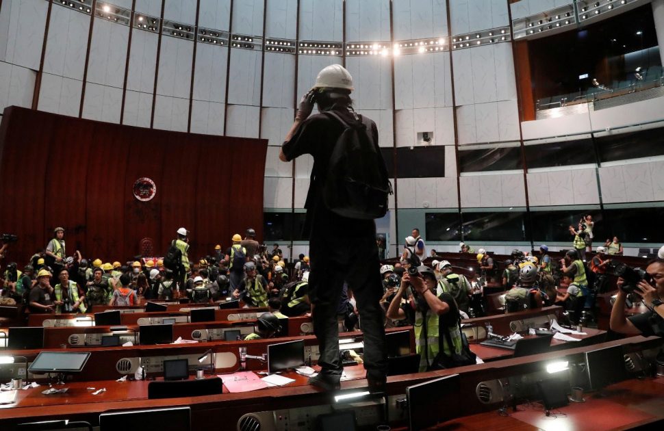 People are seen inside a chamber, after protesters broke into the Legislative Council building during the anniversary of Hong Kong’s handover to China in Hong Kong, China July 1, 2019. The banner reads “There are no thugs, only tyranny”. REUTERS/Tyrone Siu