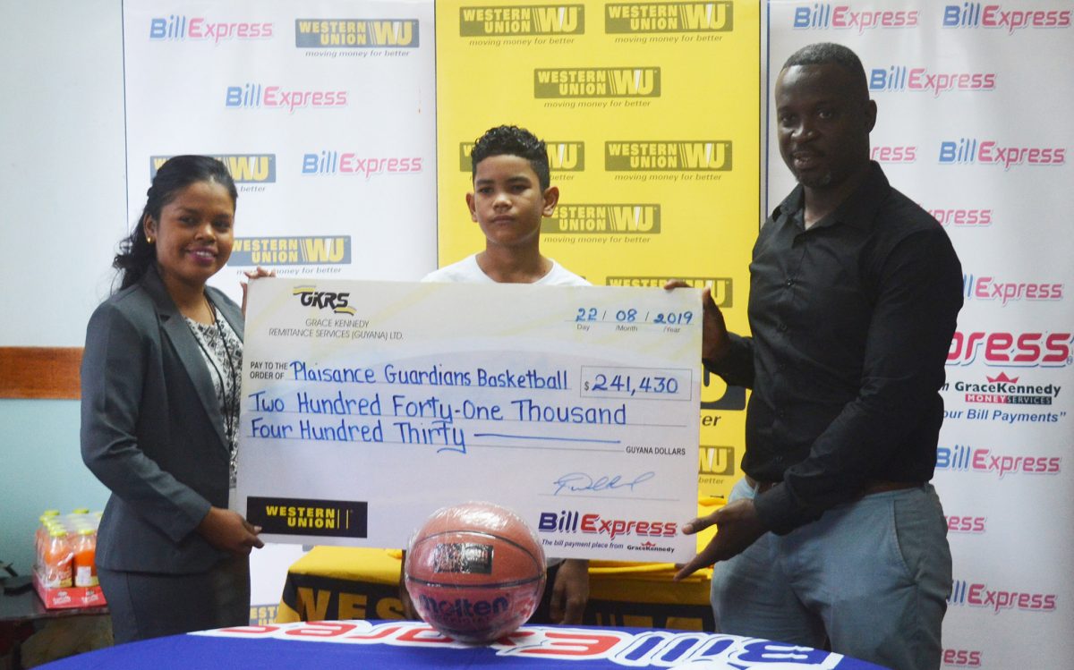 Junior Hercules (right), head of the HBA, collecting the sponsorship cheque from GraceKennedy Marketing Assistant Tina Gibson (left) in the presence of the camp participant Marion Fiedtkou.