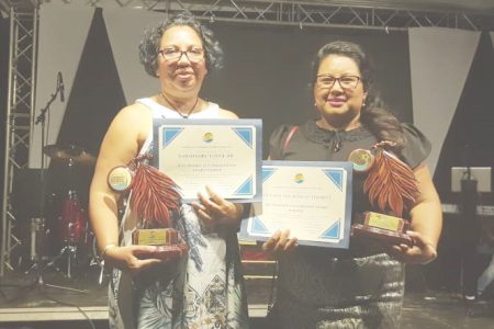 From left are Melanie McTurk, of Karanambu Lodge, and Carla James, Deputy Director of the Guyana Tourism Authority, who are displaying the awards that were conferred on Thursday during the Caribbean Sustainable Tourism Awards in St. Vincent and the Grenadines. (GTA photo)

