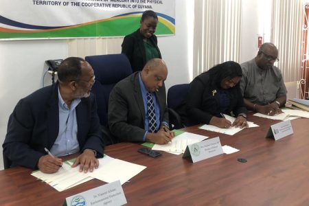 From left are Executive Director of the EPA Vincent Adams, Minister of Natural Resources Raphael Trotman, Registrar of the PTCCB Trecia David-Garnath and Commissioner of the GGMC Newell Dennison signing the MOU yesterday. 