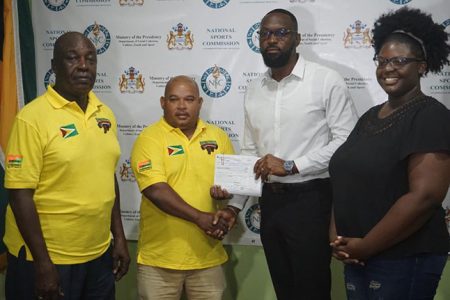  Director of Sport Christopher Jones (second from right) presented a cheque for $3.6 million to GAPF Treasurer Colin Austin (second from left) in the presence of GAPF President Ed Caesar (left) and PRO and athlete, Runita White yesterday. (Emmerson Campbell photo)
