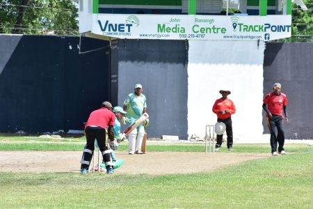 Off-spinner Sham Persaud (right) bowling to Safraz Sheriffudeen while Ronald Jaisingh is at the non-striker’s end.
