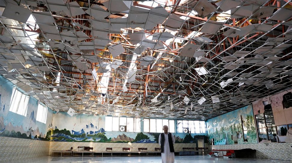 An Afghan man inspects a damaged wedding hall after a blast in Afghanistan’s Kabul on August 18, 2019. Photo: Reuters