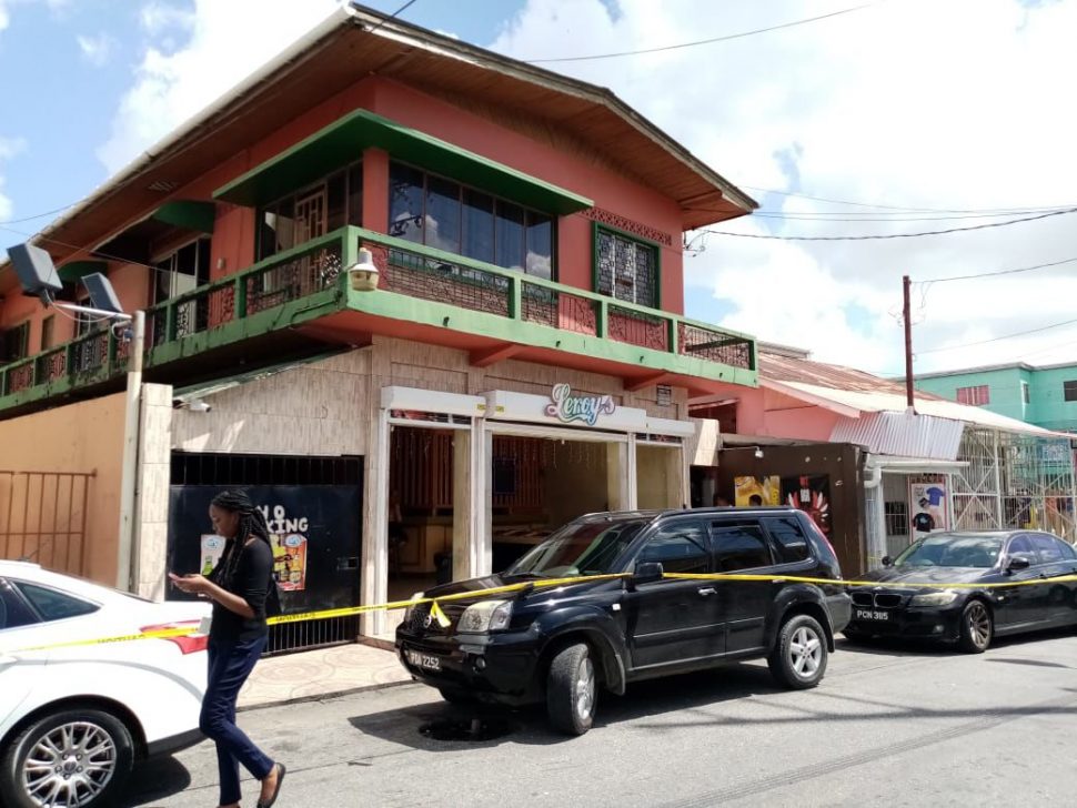 Police officers at the scene where local actor Raymond Choo Kong was murdered at his Arima home in the vicinity of the Police Station  -Photo: MICHEAL MONDEZIE 