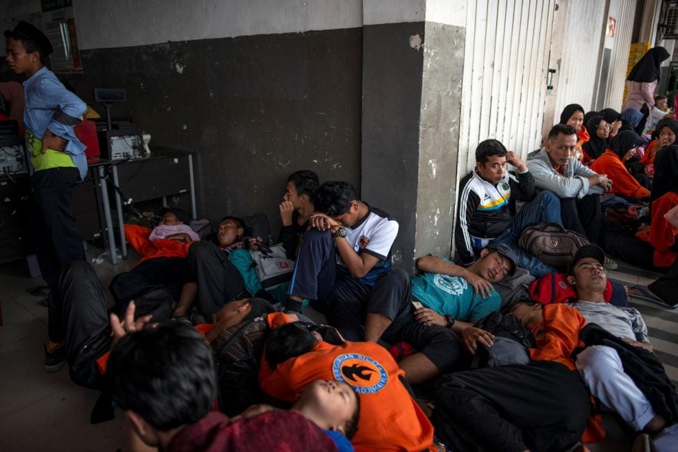 Commuter train passengers rest as they wait to travel to Jakarta outside a station, closed due to a major power blackout, in Banten, Indonesia, August 4, 2019. REUTERS/Arimacs Wilander