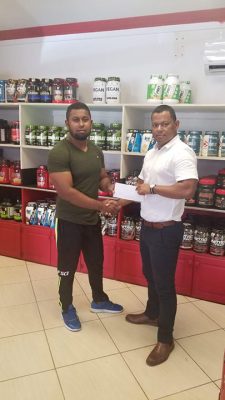 Organizing Secretary of the GBBFFI, Videsh Sookram (left) receives the sponsorship cheque from Fitness Express’ Manager, Ian Rogers recently at the company’s store at 47 John and Sheriff Streets.
