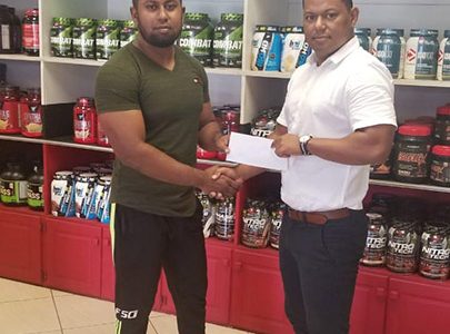 Organizing Secretary of the GBBFFI, Videsh Sookram (left) receives the sponsorship cheque from Fitness Express’ Manager, Ian Rogers recently at the company’s store at 47 John and Sheriff Streets.
