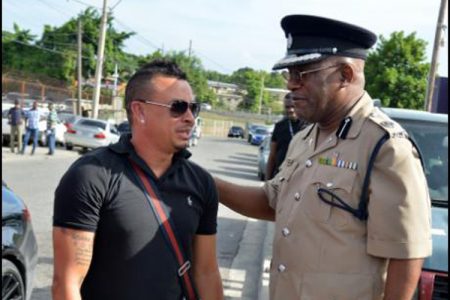 Assistant Commissioner of Police Bishop Dr. Gary Welsh, former head of the Public Safety and Traffic Enforcement Branch, speaking with Dennis Dietrih, a man who admitted to performing dangerous stunts on the road.