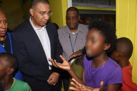 little girl who is a ward of the state asks Prime Minister Andrew Holness what would be her fate and that of 40 other children after fire destroyed their home on Friday evening. (Photo: Karl Mclarty) 
