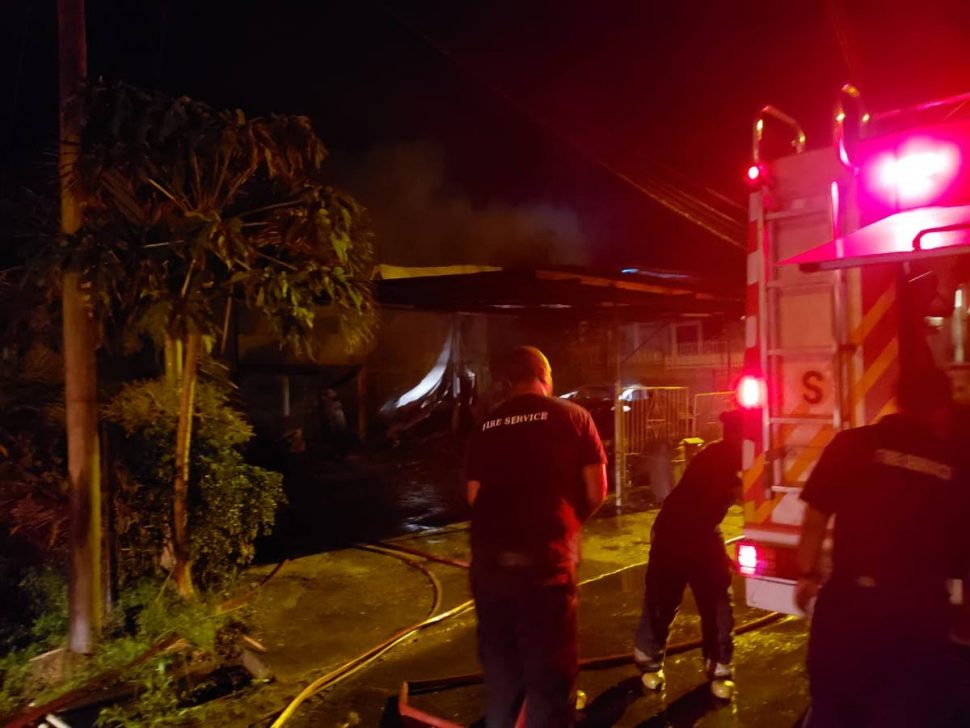 Fire-fighters at the scene of the fire which destroyed a house and cars at Chatam, Cedros on Friday night.