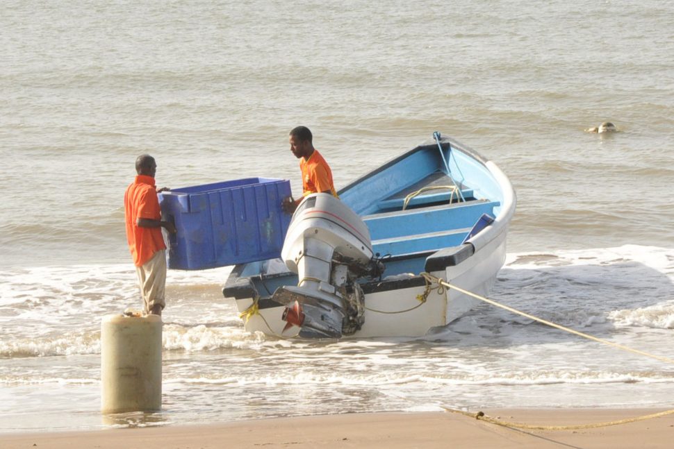 Fishermen prepping their boat to go out to sea at Bonasse Village, Cedros.