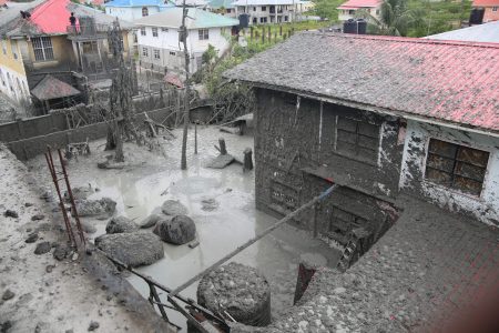 The back of the yard (foreground) after the well erupted (SN file photo)