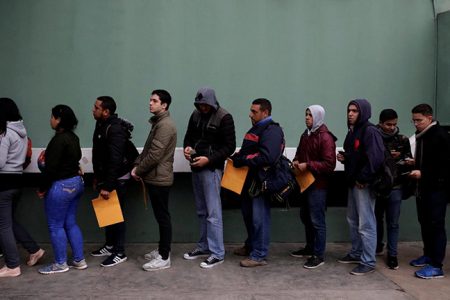 Venezuelan migrants queue to get their background criminal records outside a police office in Lima, Peru, June 11, 2019. REUTERS/Guadalupe Pardo/Files