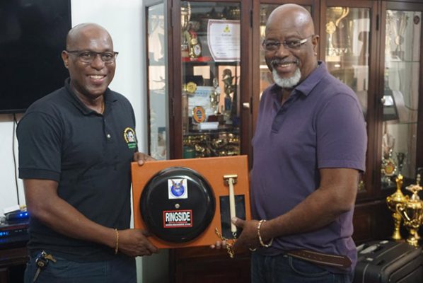 Harold Hopkinson, CEO of Secure Innovations and Concept Inc. presented a ringside boxing bell to President of the Guyana Boxing Association, Steve Ninvalle.