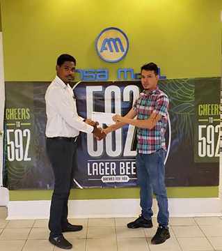 592 Beer Brand Manager Seweon McGarrell hands over the sponsorship package to tournament coordinator Michelangelo Jacobus at the Ansa McAl Head Office.
