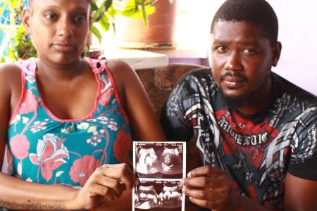 Crystal Carrington and Kurt Goddard hold an ultrasound picture of their daughter Olivia at their San Juan home yesterday.