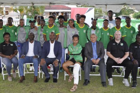 Minister of Social Cohesion with responsibility for Culture, Youth and Sport Dr. George Norton [sitting 3rd from right] posing with members of the Guyana National Women’s U17 and U20 teams as well as the Boys u15 side at the GFF Appreciation Reception
