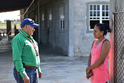 Minister of Indigenous Peoples’ Affairs, Sydney Allicock (left) speaks with Foulis Resident Subrina Ramoop on a walkabout the village. (DPI photo)