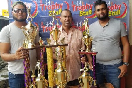 from left, Vinash Rampersaud, club captain, Ramesh Sunich of the Trophy Stall and Abhilash Deokie president of the SandPipers Cricket Club.