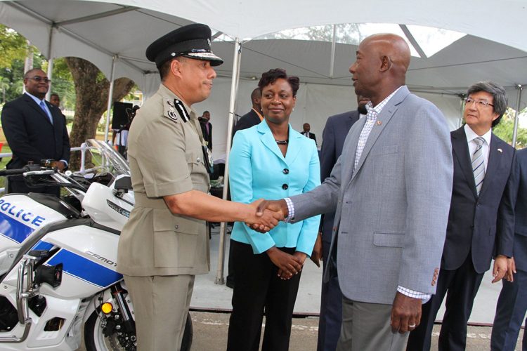 Prime Minister Dr Keith Rowley (right) greets Police Commissioner Gary Griffith at a ceremony to hand over motorcycles given to the Trinidad and Tobago Police Service by the People’s Republic of China, at the Police Academy in St James on Wednesday. 