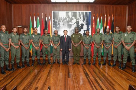 China’s Ambassador to Guyana Cui Jianchun and GDF Chief-of-Staff Brigadier Patrick West (sixth, from right) with the scholarship awardees at the Ministry of the Presidency on Wednesday. (Ministry of the Presidency photo)