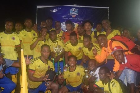 The victorious Eagles FC posing with their spoils after defeating Botofago 3-1 in the inaugural Divine Entertainment Summer Super Cup Football Championship at the MSC ground, Linden
