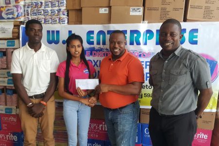 WJ Enterprise supervisor Kavita Sukhu presenting the sponsorship cheque to Co-Director of the Petra Organization Troy Mendonca [2nd from right] towards the fourth annual Limacol Football Championship in the presence of Petra Organization members Mark Alleyne [left] and Sean Embrack [right].
