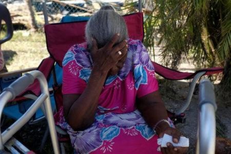 A woman reacts at her home after Hurricane Dorian hit the Abaco Islands in Marsh Harbour, Bahamas, September 5, 2019. REUTERS/Marco Bello