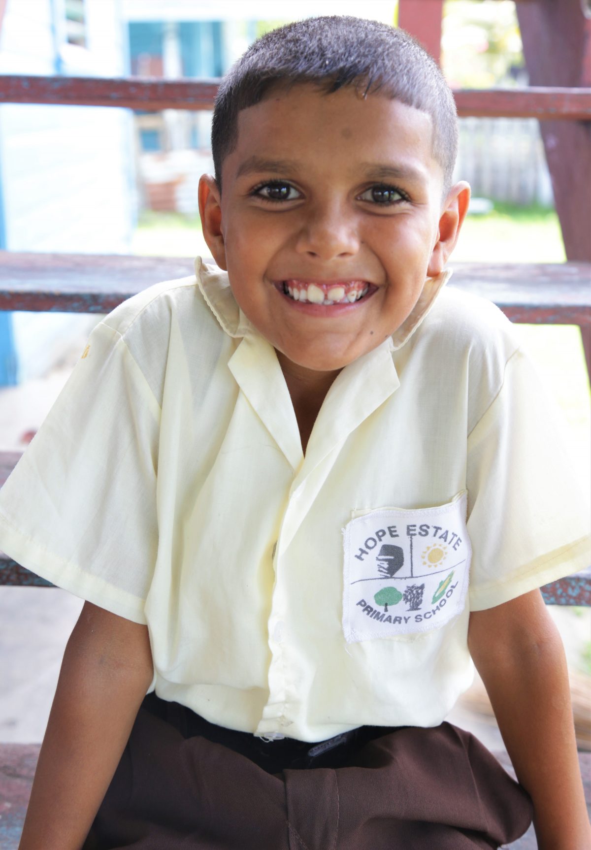 Parsram Budhu’s great grandson poses in his Hope Estate Primary School uniform 
