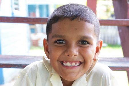 Parsram Budhu’s great grandson poses in his Hope Estate Primary School uniform
