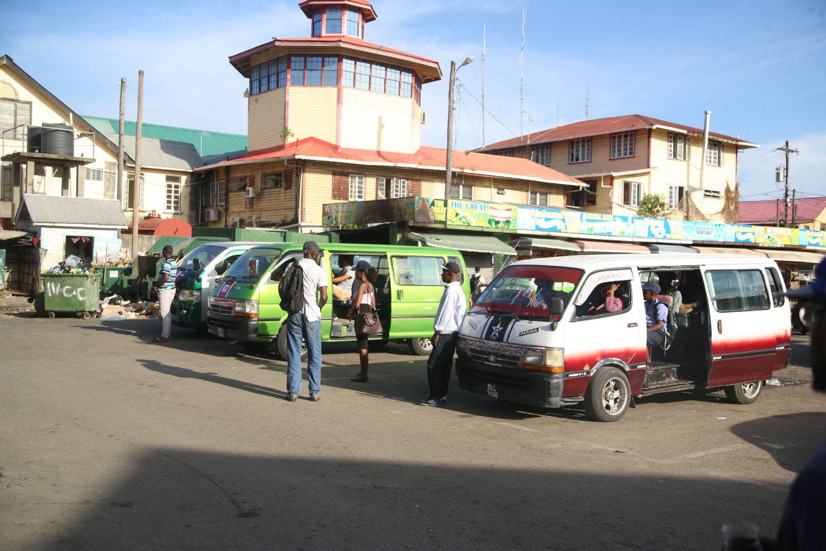 Commuters boarding buses at the Stabroek bus park (File Photo by Terrence Thompson)