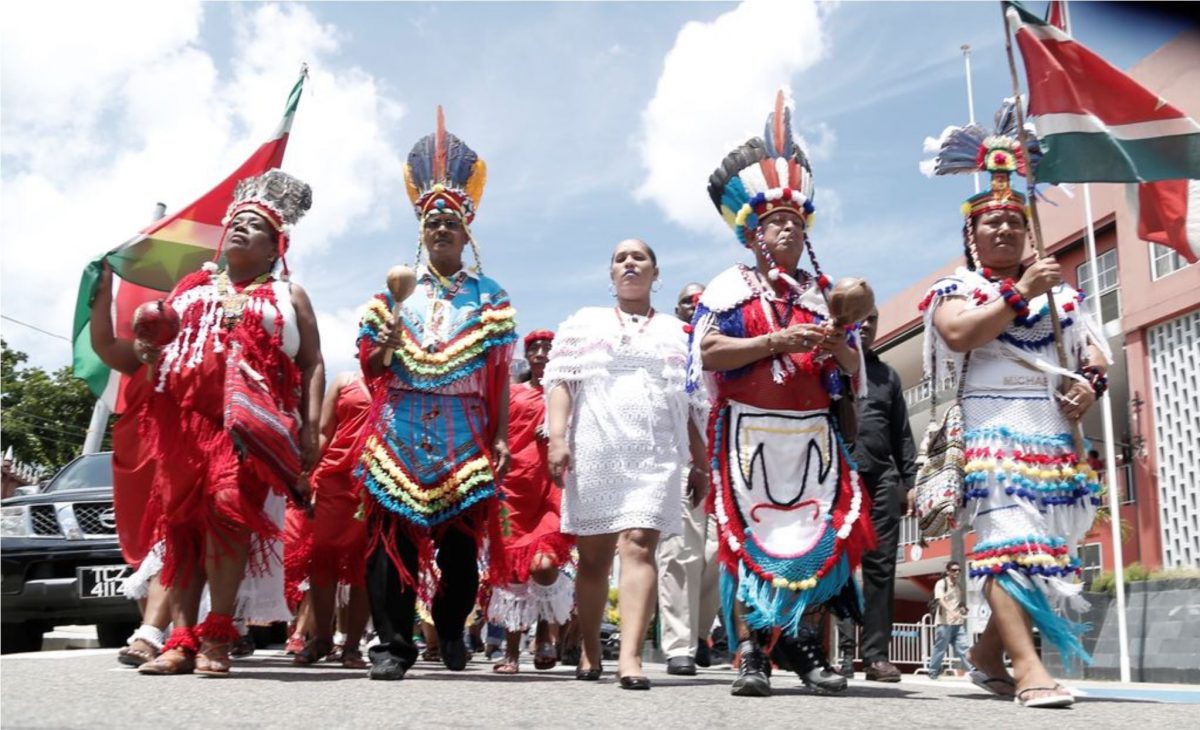 Chief of the First Peoples, Ricardo Hernandez, second from right, is accompanied by Arima Mayor Lisa Morris-Julian, third from left, and members of the first people from Suriname as they take part in an annual street parade. (Trinidad Guardian photo)
