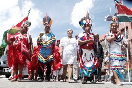 Chief of the First Peoples, Ricardo Hernandez, second from right, is accompanied by Arima Mayor Lisa Morris-Julian, third from left, and members of the first people from Suriname as they take part in an annual street parade. (Trinidad Guardian photo)
