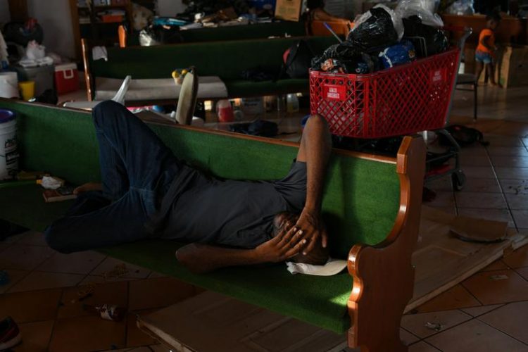 A man rests inside a damaged church serving as a shelter for Abaco residents who lost their homes to Hurricane Dorian in Marsh Harbour, Great Abaco, Bahamas, September 8, 2019. REUTERS/Loren Elliott
