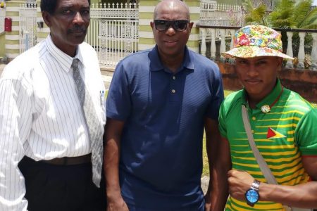 Keevin Allicock (right) and Elton Chase (left) pose for a photo with President of the Guyana Boxing Association (GBA), Steve Ninvalle prior to departure on Saturday.
