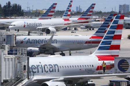 FILE – In this April 24, 2019, photo, American Airlines aircraft are shown parked at their gates at Miami International Airport in Miami. An American Airlines mechanic is accused of sabotaging a flight from Miami International Airport to Nassau in the Bahamas, over stalled union contract negotiations. Citing a criminal complaint affidavit filed in federal court, The Miami Herald reports Abdul-Majeed Marouf Ahmed Alani was arrested Thursday, Sept. 5, 2019, on the sabotage charge and is accused of disabling the flight’s navigation system. (AP Photo/Wilfredo Lee, File)