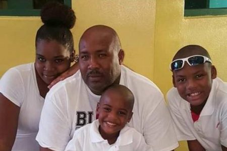 Jamaican Richard Little and his wife, Doralee, pose for a photo with their sons Richard Jr (right) and Rayjay.