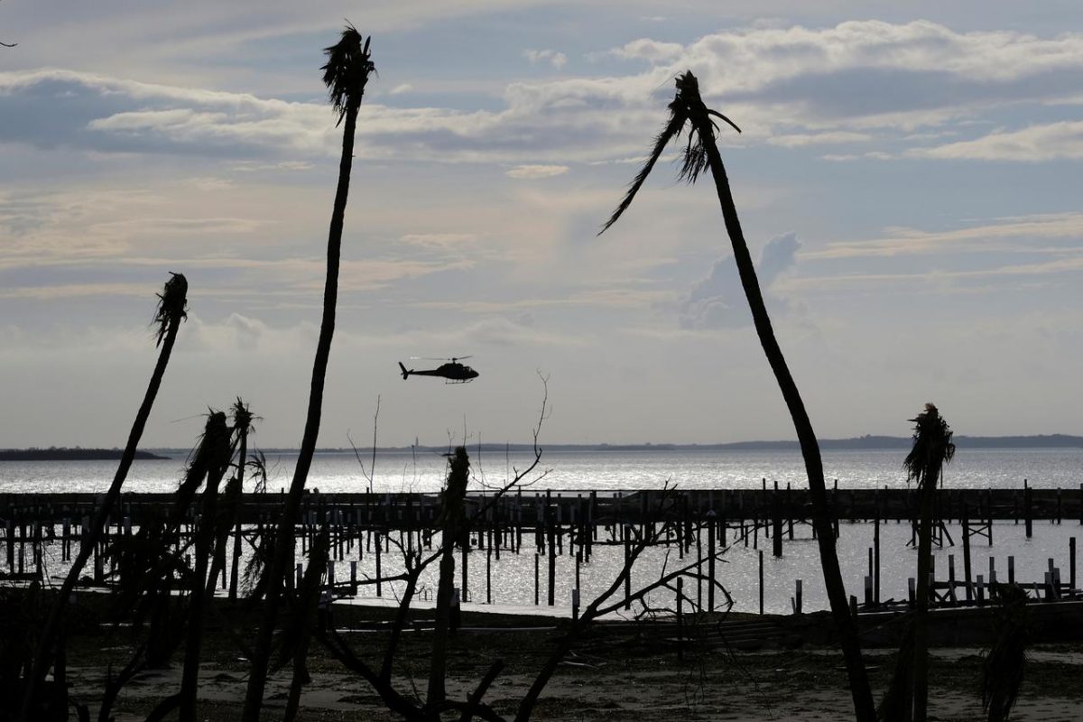 An unidentified helicopter lands to deliver food and water in the aftermath of Hurricane Dorian on the Great Abaco island town of Marsh Harbour, Bahamas, September 4, 2019. REUTERS/Dante Carrer/File Photo