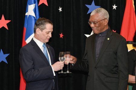 President David Granger and Chilean Ambassador to Guyana Patricio Becker share a toast. (Ministry of the Presidency photo)