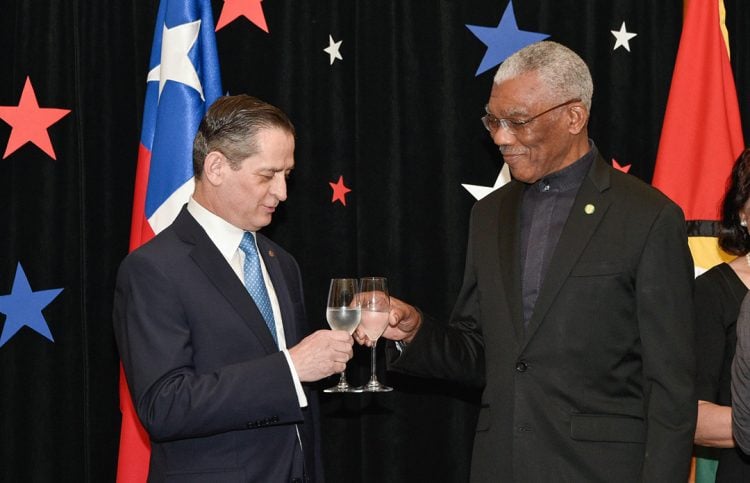 President David Granger and Chilean Ambassador to Guyana Patricio Becker share a toast. (Ministry of the Presidency photo)