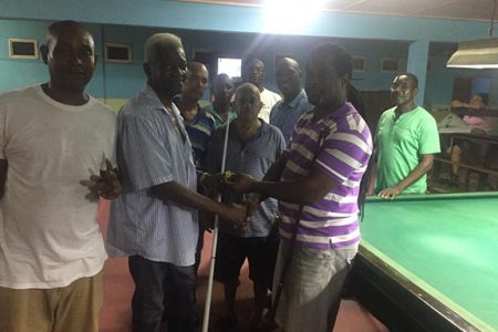 Hardcourt Warde [2nd from left] hands over the playing chalk to MSC Committee Member Troy Roberts prior to the start of the Keith Moseley Memorial Billiards Championship at the Mackenzie Sports Club [MSC], Linden